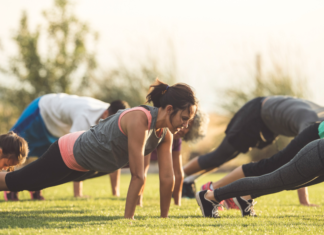 A group of people exercising in a park.
