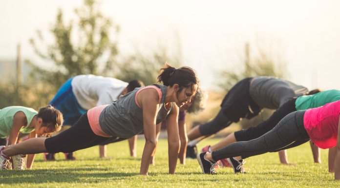 A group of people exercising in a park.