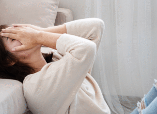A woman covering her face.