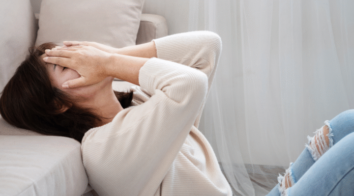 A woman covering her face.