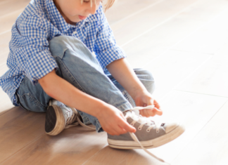 Get Your Sneakers On! My Children’s Daily Evil Plot Against Me A boy tying his shoe.