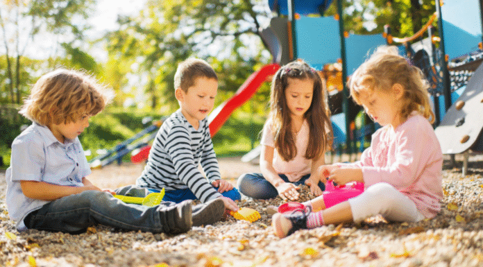 Kids playing in the dirt at a playground.
