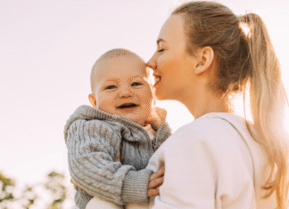 Motherhood: Recognizing Joy A mother kissing her babies head.