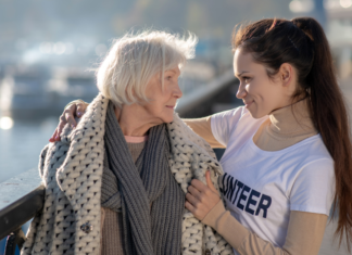 26 Days Of Kindness A woman helping a homeless woman to spread kindness.