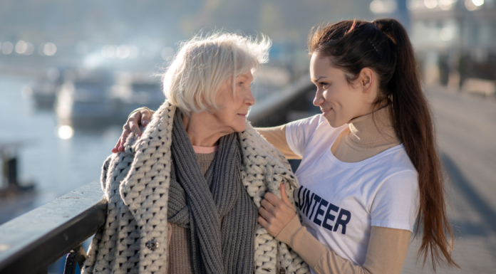 A woman helping a homeless woman to spread kindness.