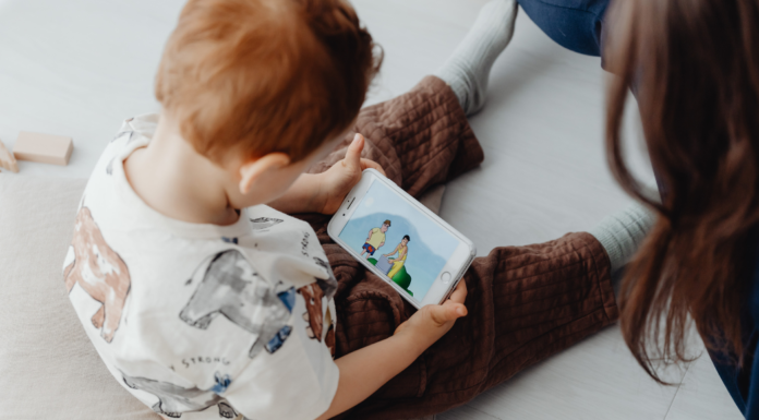 A preschooler on a phone watching Paw Patrol.