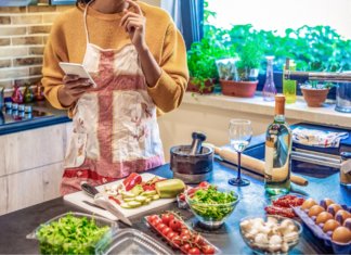 A woman cooking several meals.