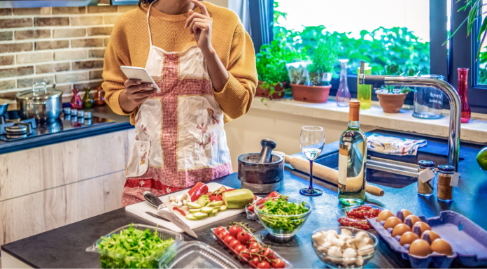 A woman cooking several meals.