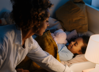 A mom putting her son to sleep.