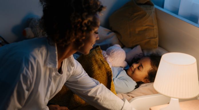 A mom putting her son to sleep.