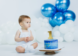 You Made Me a Mama: A Letter to My Baby on His First Birthday A boy sitting next to his first birthday cake and balloons.