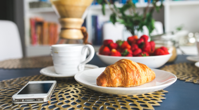 A simple breakfast of a croissant and strawberries.