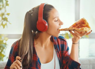 Top Five Most Satisfying Things {Mom Edition} A girl eating pizza listening to headphones.