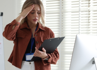 A stressed woman holding her head.