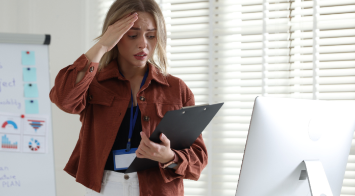 A stressed woman holding her head.