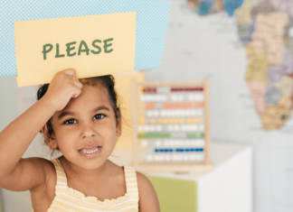 Can We Please Save Manners? We Need to Save Empathy! A girl holding a sign that says "please."