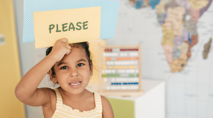 A girl holding a sign that says "please."
