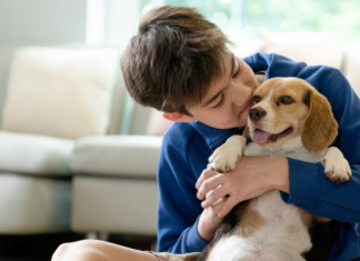 Mom, Can I Have a Pet? A boy kissing a puppy.