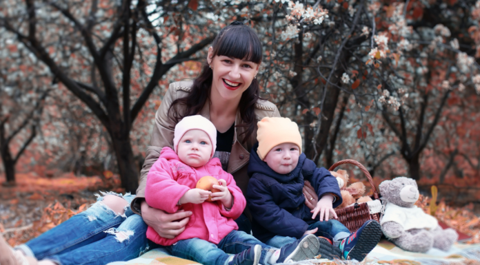 A mom with her twins in the park.