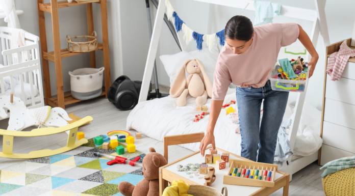 A woman cleaning up a messy bedroom.