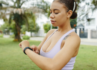 A woman looking at her Fitbit.