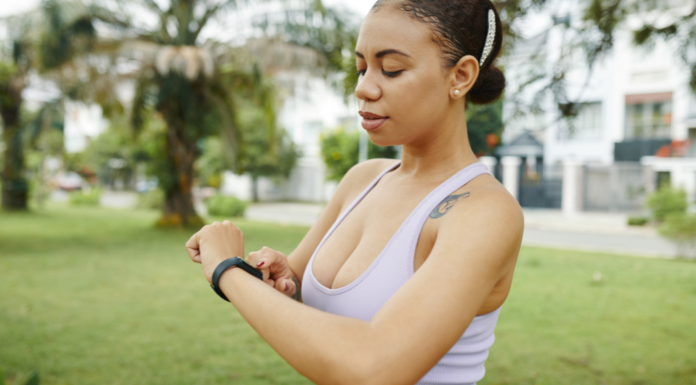 A woman looking at her Fitbit.