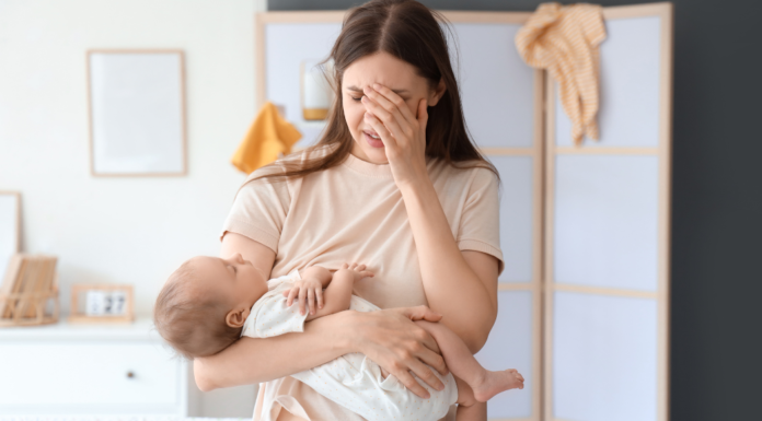 A postpartum mom holding her baby.