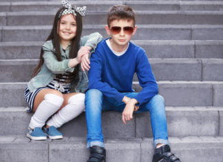 From Wearing J. Crew to Dressing My Little Zoo Kids posing on stairs.