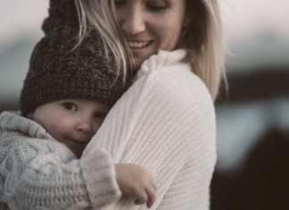 A mom holding a baby.