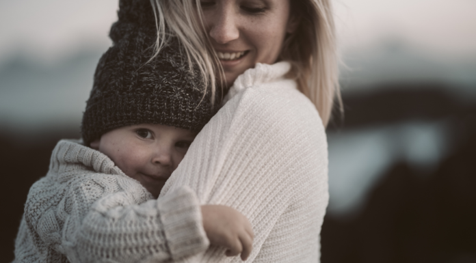 A mom holding a baby.