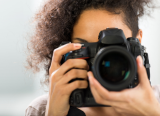 A woman holding a camera.