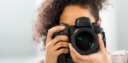 A woman holding a camera.
