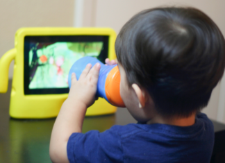 A toddler watching a screen.