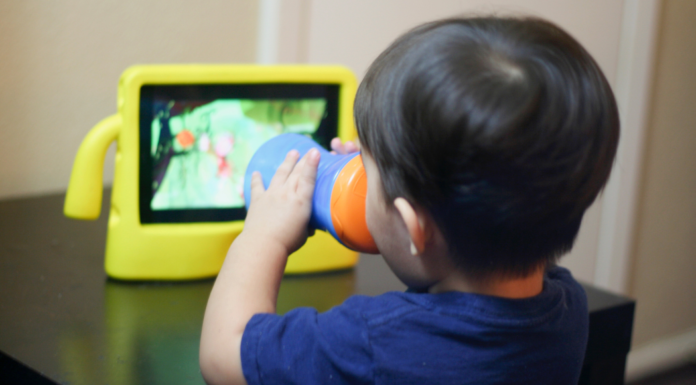 A toddler watching a screen.