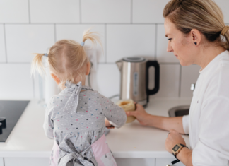 A mom cooking with her daughter.