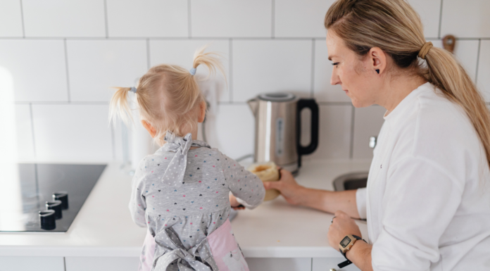 A mom cooking with her daughter.