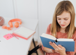 Read Her Stories: Historical Women in Picture Books A girl reading a women's history book.