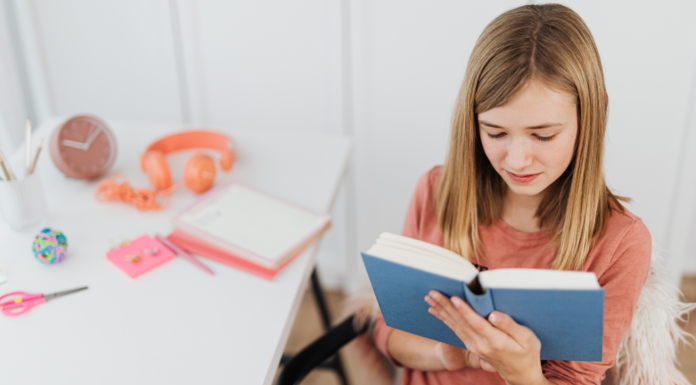 A girl reading a women's history book.
