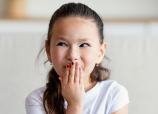 A Simple Way to Stop a Foul Word A girl covering her mouth.