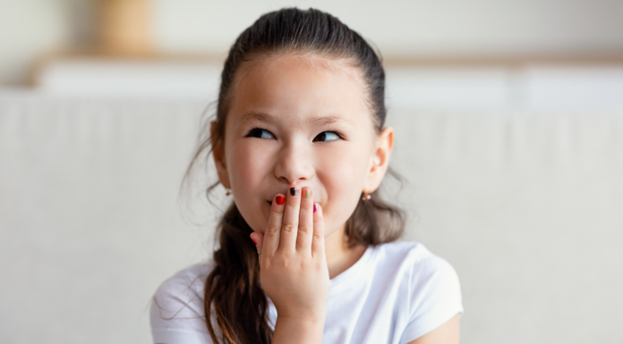 A girl covering her mouth.