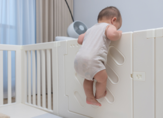 The Great Baby Escape! (Ways to Keep Your Child Safely in their Crib) A baby climbing out of a crib.