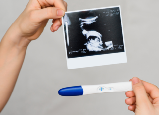 A pregnancy test and ultrasound picture.
