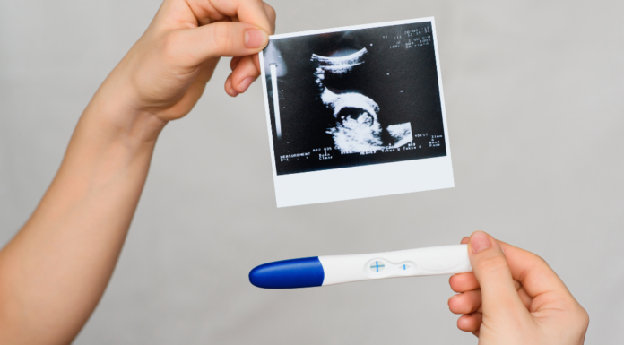 Opposite Sides of Fertility A pregnancy test and ultrasound picture.
