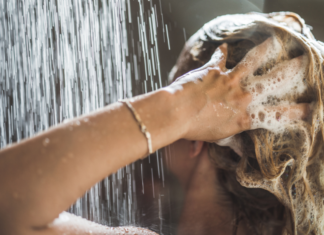 Washing your hair with shampoo.