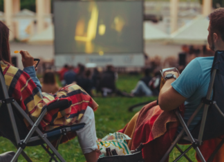 A couple watching an outdoor movie.