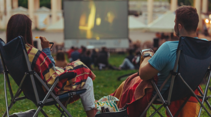 A couple watching an outdoor movie.