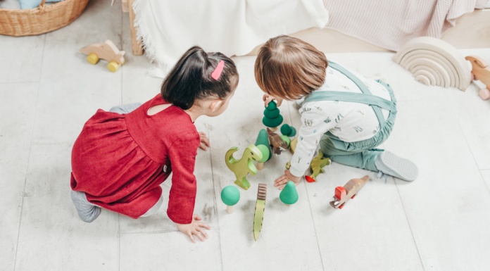 Two toddlers playing together during a play date.