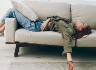 A woman laying on the couch.
