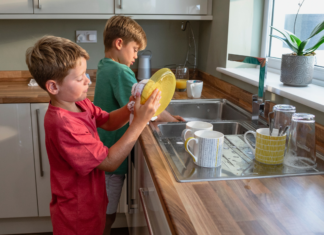 Boys washing dishes.