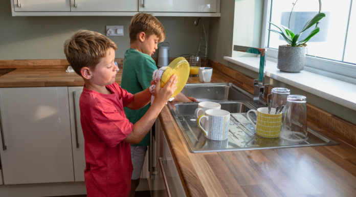 Boys washing dishes.